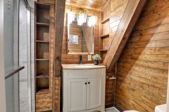 bathroom with wood walls, vanity, wood ceiling, and toilet