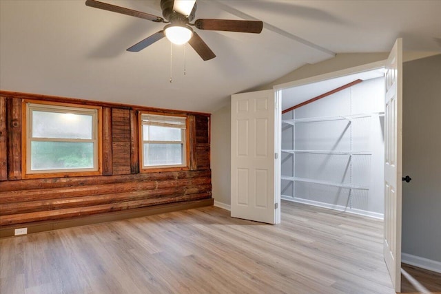 unfurnished bedroom with ceiling fan, light hardwood / wood-style floors, and vaulted ceiling