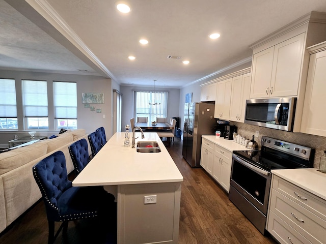 437 Arrowwood Dr, Grovetown, GA 30813 - kitchen with crown molding, open floor plan, recessed lighting, a sink, and appliances with stainless steel finishes