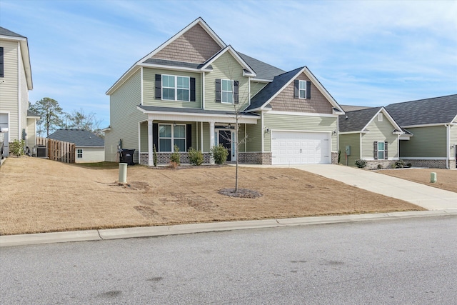 craftsman-style house with central AC unit, a porch, and a garage