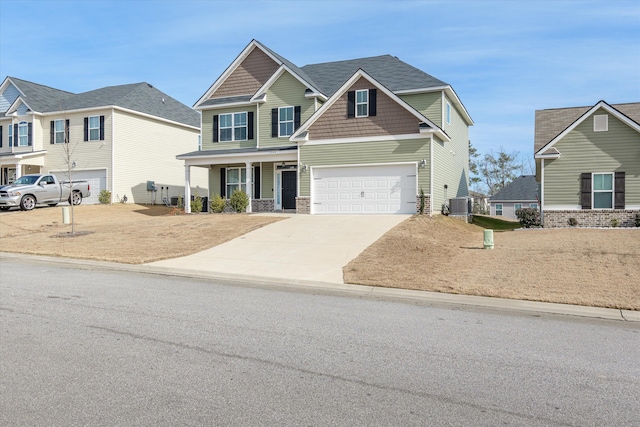 craftsman house with a garage, central AC unit, and covered porch