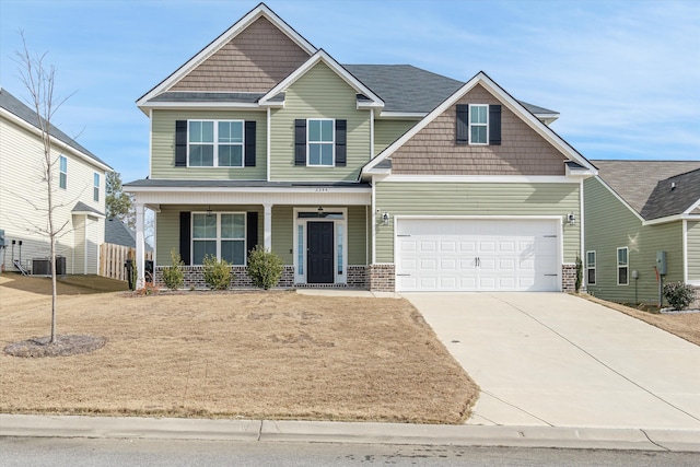 craftsman-style house featuring covered porch, a garage, and cooling unit