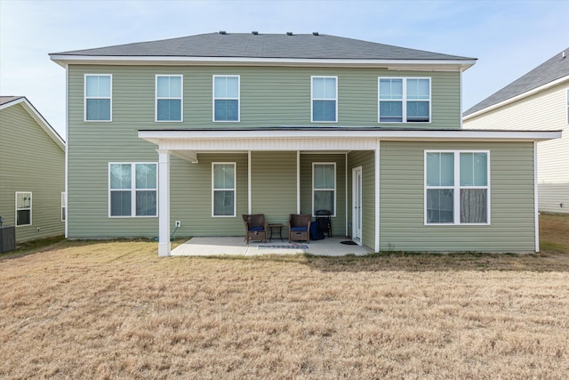 back of property featuring a patio area, cooling unit, and a lawn