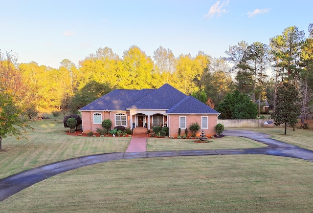 single story home featuring a front lawn and a porch