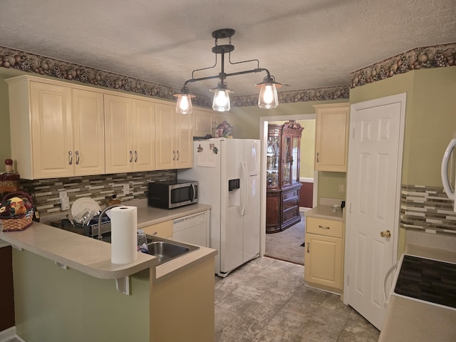 kitchen with pendant lighting, a kitchen breakfast bar, decorative backsplash, and white appliances