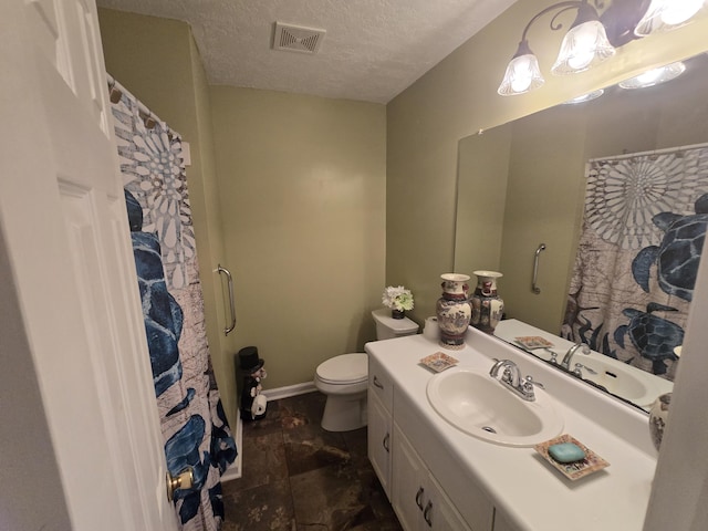 bathroom with vanity, a textured ceiling, and toilet