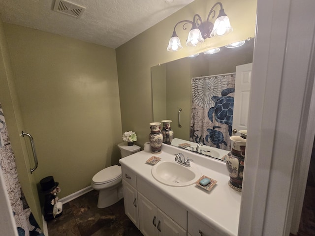 bathroom featuring vanity, a textured ceiling, and toilet