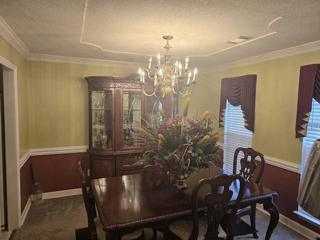 dining space with carpet floors, ornamental molding, a textured ceiling, and a notable chandelier