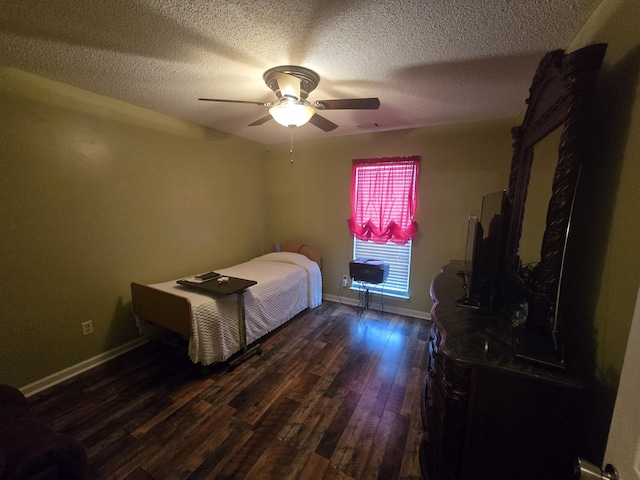 bedroom with ceiling fan, dark hardwood / wood-style floors, and a textured ceiling