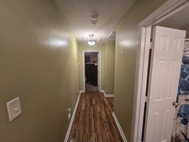 hallway featuring dark hardwood / wood-style floors and a textured ceiling