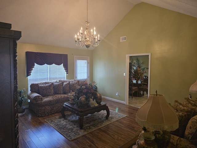 living room featuring high vaulted ceiling, dark wood-type flooring, and a notable chandelier