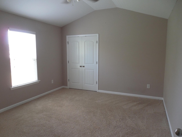 130 Clarinbridge Ln, Grovetown, GA 30813 - unfurnished bedroom featuring light carpet, vaulted ceiling, a closet, and baseboards
