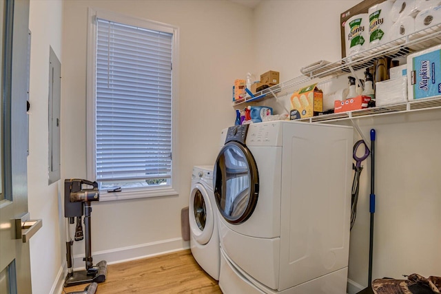 341 Crown Pt, Mccormick, SC 29835 - clothes washing area with light wood-style floors, electric panel, washing machine and dryer, baseboards, and laundry area