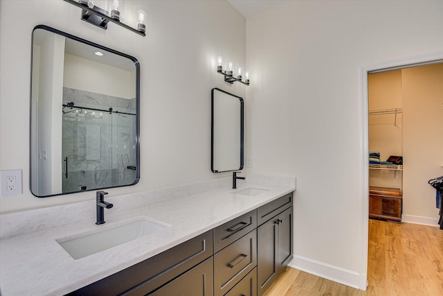 341 Crown Pt, Mccormick, SC 29835 - full bath featuring a shower stall, wood finished floors, a sink, and a spacious closet