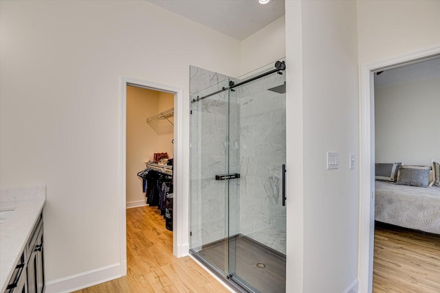 341 Crown Pt, Mccormick, SC 29835 - bathroom featuring wood finished floors, baseboards, and a marble finish shower