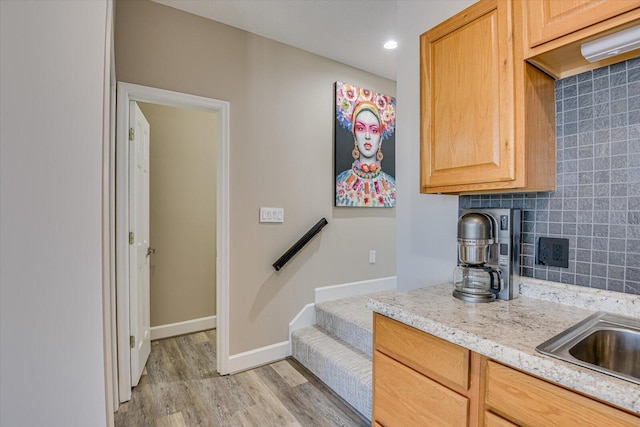 341 Crown Pt, Mccormick, SC 29835 - kitchen featuring light stone countertops, light wood-style flooring, baseboards, and backsplash