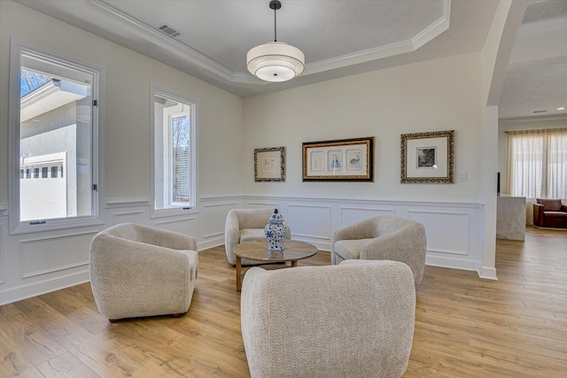 341 Crown Pt, Mccormick, SC 29835 - living area with visible vents, light wood-style flooring, ornamental molding, and a raised ceiling