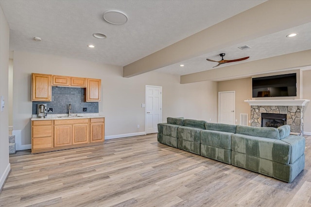 341 Crown Pt, Mccormick, SC 29835 - living room with light wood finished floors, a stone fireplace, and baseboards