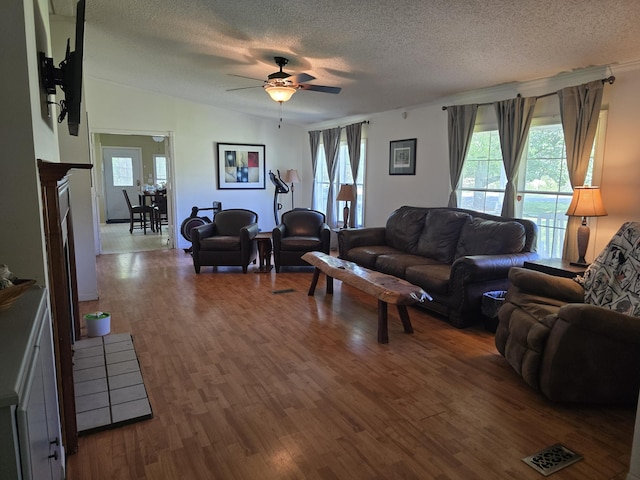6712 Janes Rd, Appling, GA 30802 - living area with visible vents, a ceiling fan, wood finished floors, and a textured ceiling