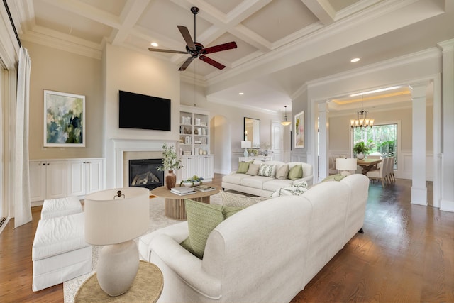 151 Commonwealth Way, Aiken, SC 29803 - living room featuring ornate columns, a decorative wall, a glass covered fireplace, a ceiling fan, and crown molding