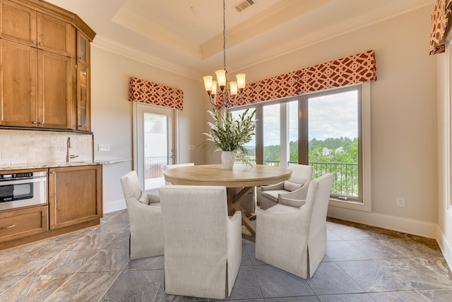 151 Commonwealth Way, Aiken, SC 29803 - dining area with ornamental molding, a chandelier, plenty of natural light, and a raised ceiling
