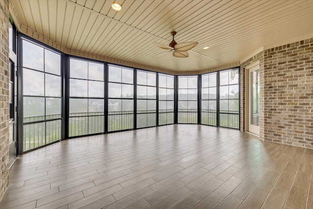 151 Commonwealth Way, Aiken, SC 29803 - unfurnished sunroom with brick wall and wood finished floors