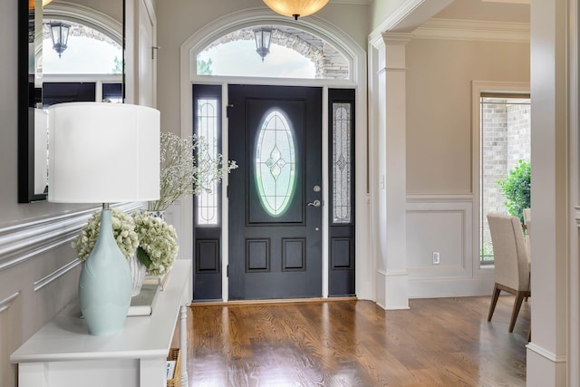 151 Commonwealth Way, Aiken, SC 29803 - foyer entrance featuring ornamental molding, a decorative wall, wood finished floors, decorative columns, and a wainscoted wall