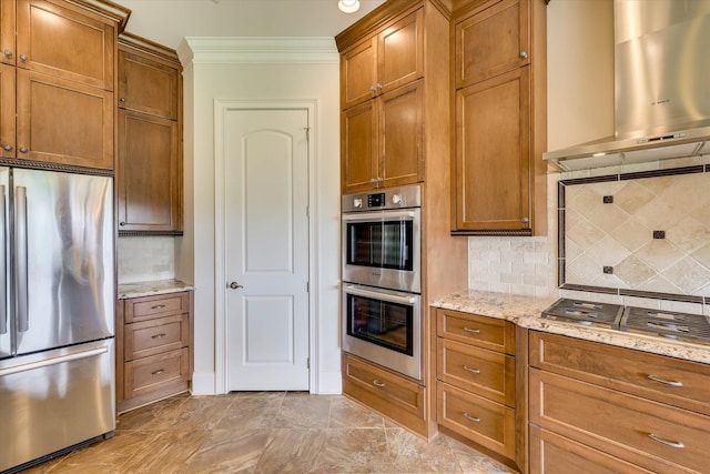 151 Commonwealth Way, Aiken, SC 29803 - kitchen featuring stainless steel appliances, wall chimney exhaust hood, ornamental molding, decorative backsplash, and brown cabinetry