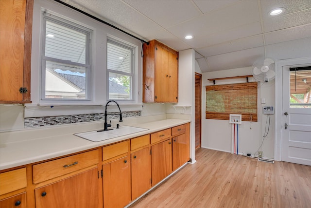 kitchen featuring a sink, light countertops, light wood-style floors, plenty of natural light, and recessed lighting