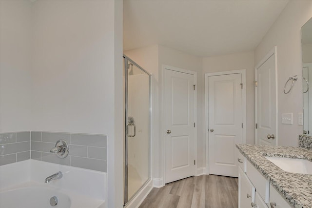 1282 Elias Sta, Thomson, GA 30824 - full bathroom with a stall shower, a garden tub, vanity, and wood finished floors