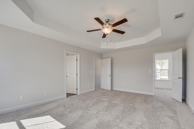 1282 Elias Sta, Thomson, GA 30824 - unfurnished bedroom with a tray ceiling, light carpet, baseboards, and ceiling fan