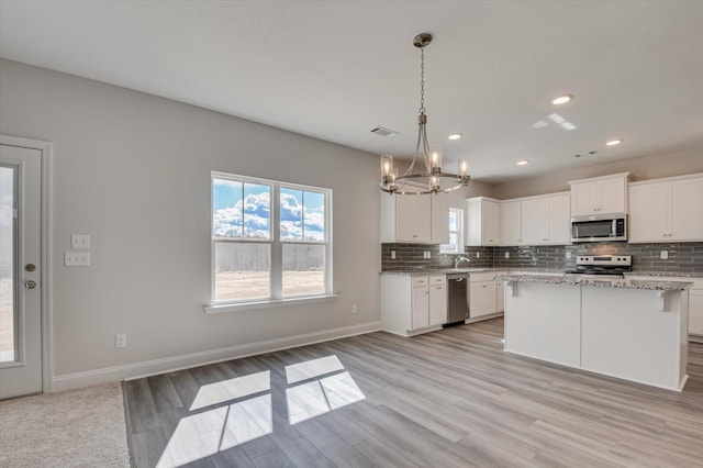 1282 Elias Sta, Thomson, GA 30824 - kitchen with appliances with stainless steel finishes, a chandelier, backsplash, light wood-style floors, and recessed lighting