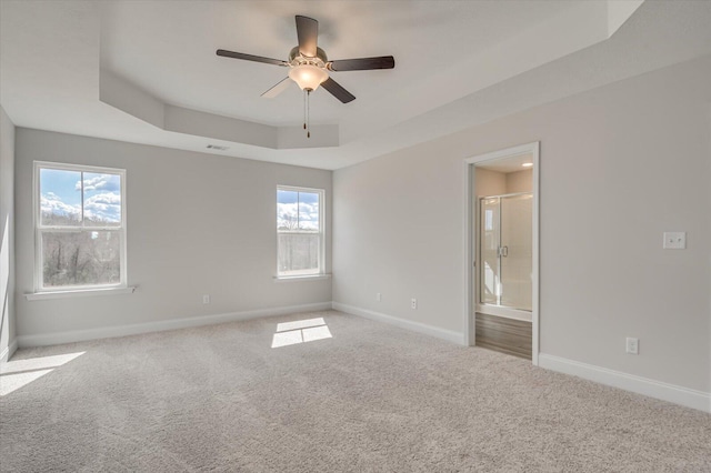 1282 Elias Sta, Thomson, GA 30824 - empty room with a tray ceiling, carpet floors, baseboards, and healthy amount of natural light