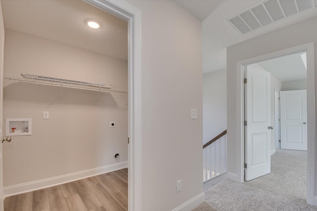 1282 Elias Sta, Thomson, GA 30824 - clothes washing area featuring electric dryer hookup, washer hookup, baseboards, and wood finished floors