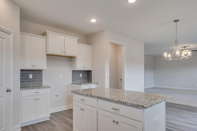 1282 Elias Sta, Thomson, GA 30824 - kitchen featuring light wood finished floors, a chandelier, light stone counters, white cabinetry, and recessed lighting