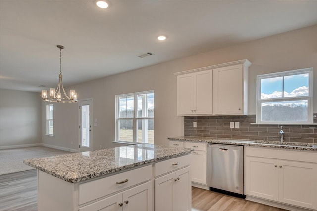 1282 Elias Sta, Thomson, GA 30824 - kitchen featuring stainless steel dishwasher, a sink, a chandelier, light wood-type flooring, and healthy amount of natural light