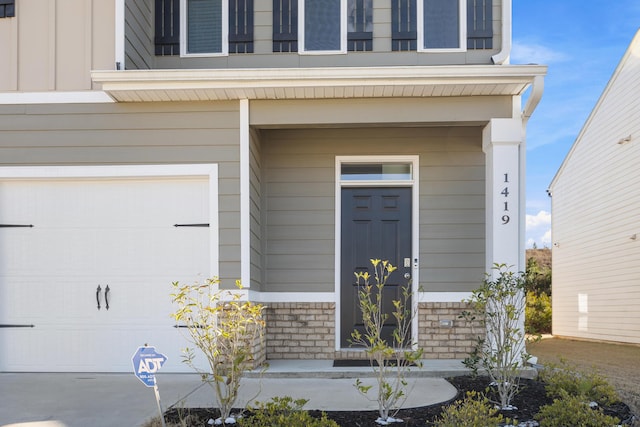 doorway to property with a garage