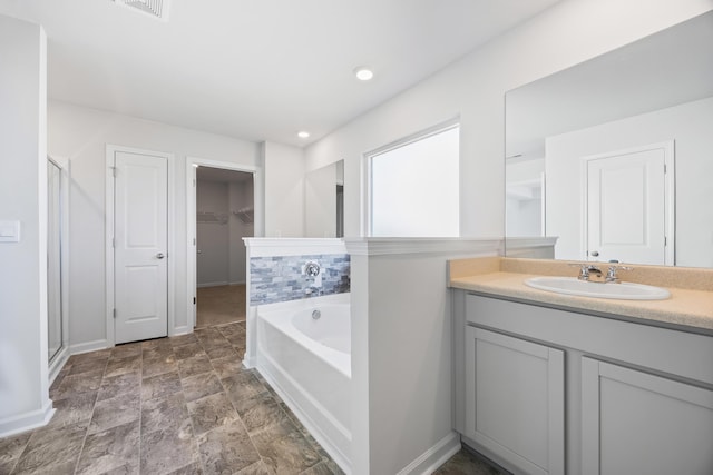 bathroom with vanity and plus walk in shower