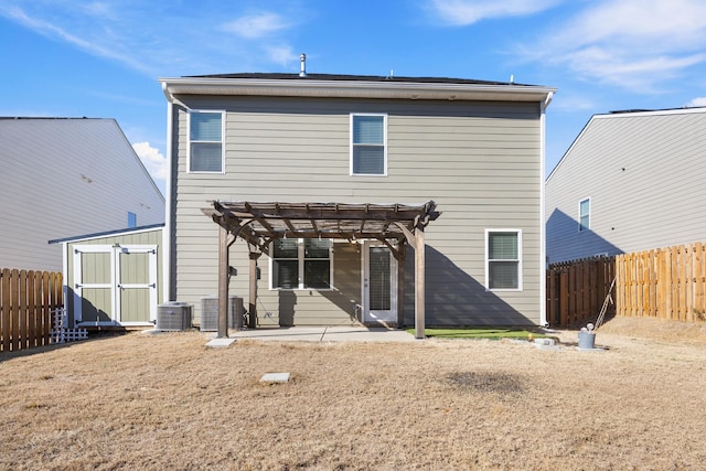 back of property featuring a patio area, central AC, a pergola, and a storage unit