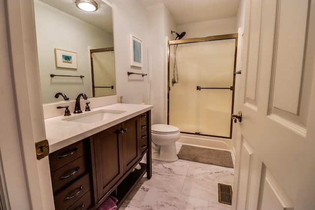 bathroom with vanity, toilet, and walk in shower