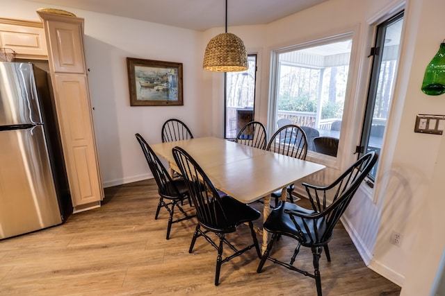 dining space with light wood-type flooring