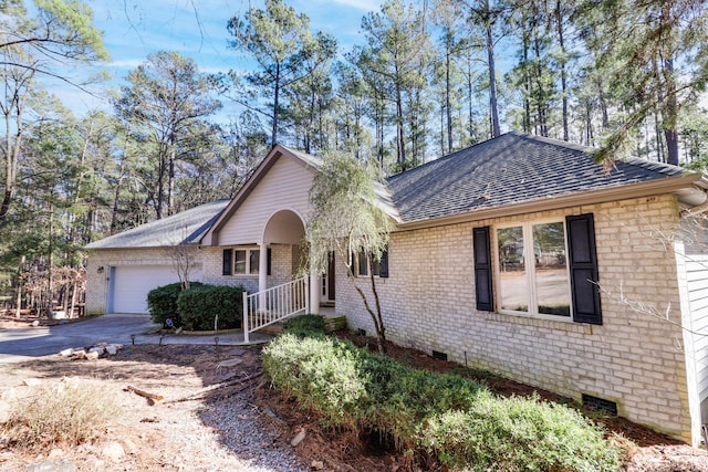 ranch-style house featuring a porch and a garage