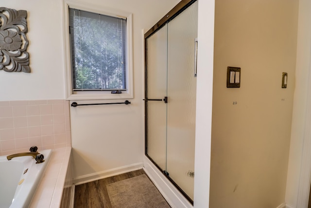 bathroom featuring hardwood / wood-style floors and shower with separate bathtub