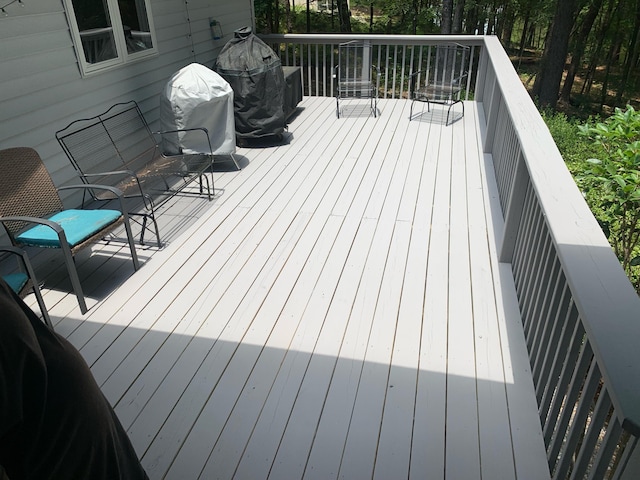 wooden deck featuring a grill