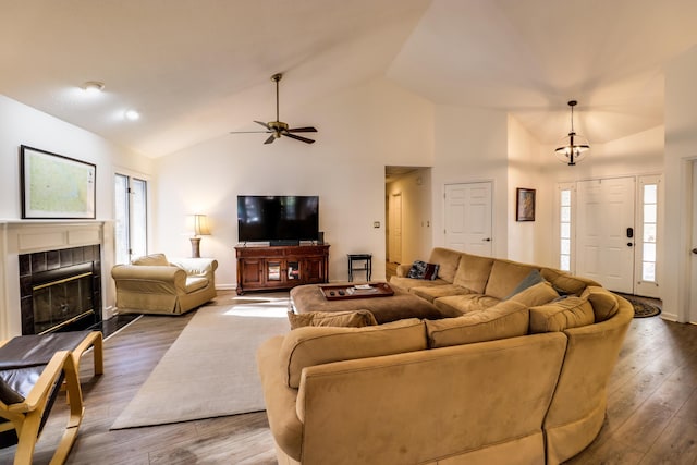 living room with plenty of natural light, ceiling fan, wood-type flooring, and a fireplace