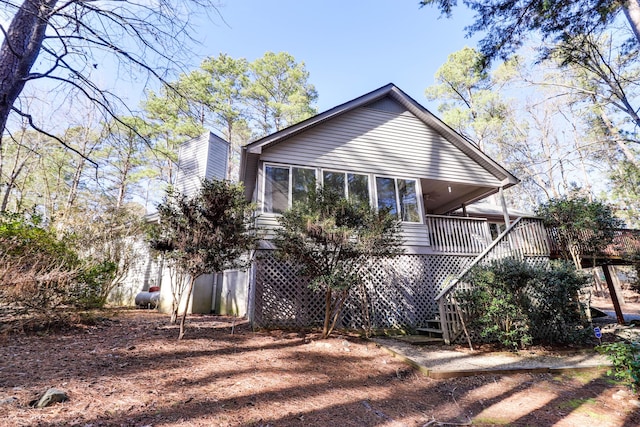 back of property with a wooden deck