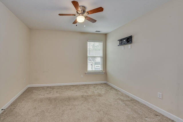 empty room with light colored carpet and ceiling fan