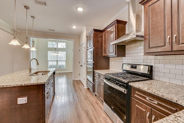 kitchen with stainless steel appliances, crown molding, sink, and wall chimney range hood