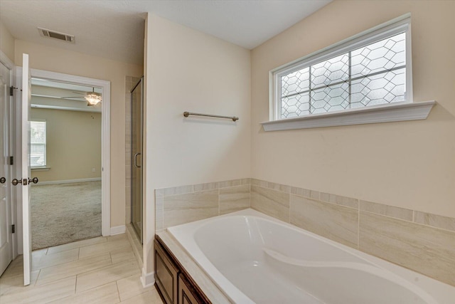 bathroom with tile patterned floors and separate shower and tub