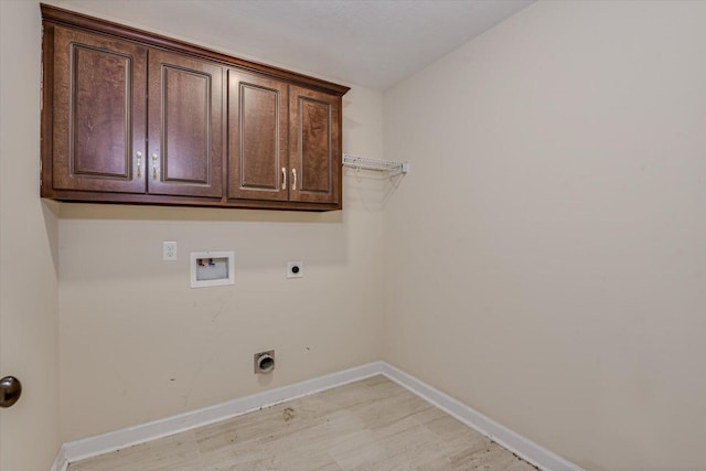 laundry room featuring cabinets, hookup for a washing machine, light hardwood / wood-style flooring, and electric dryer hookup